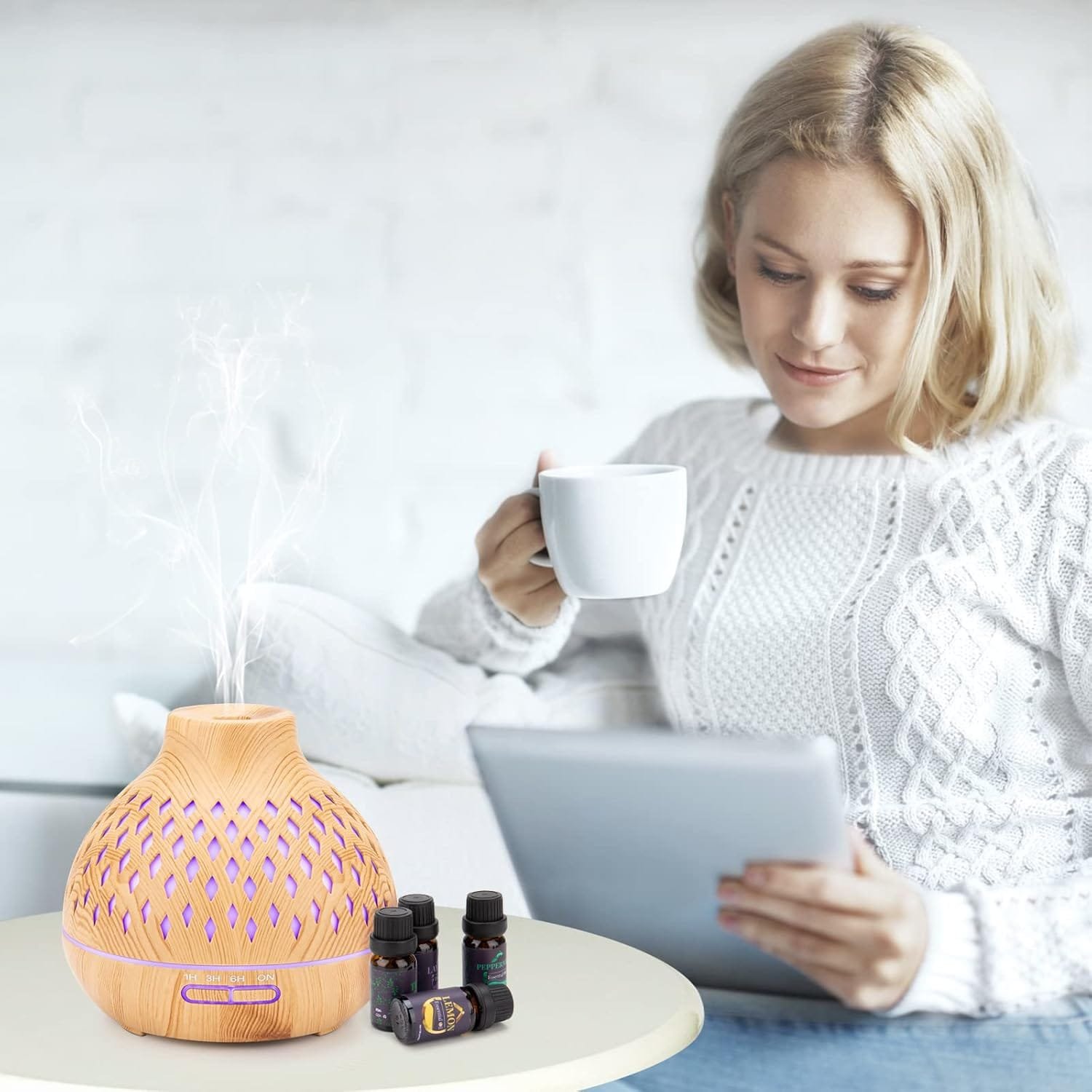 Woman meditating near colorful diffuser