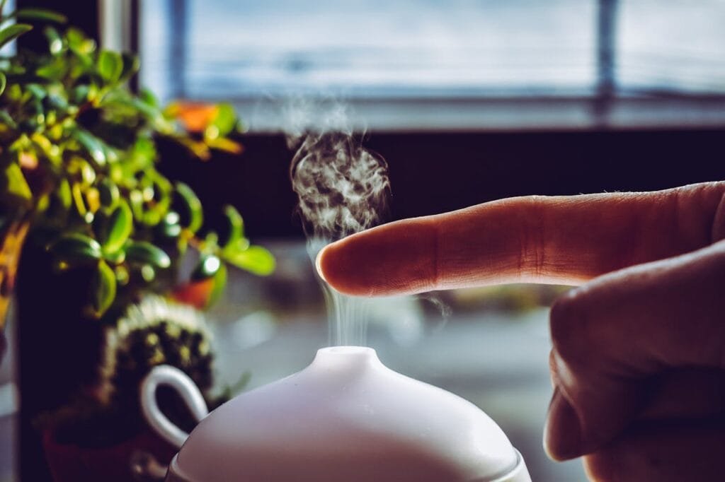 Aromatherapy diffuser releasing mist in a cozy home setting