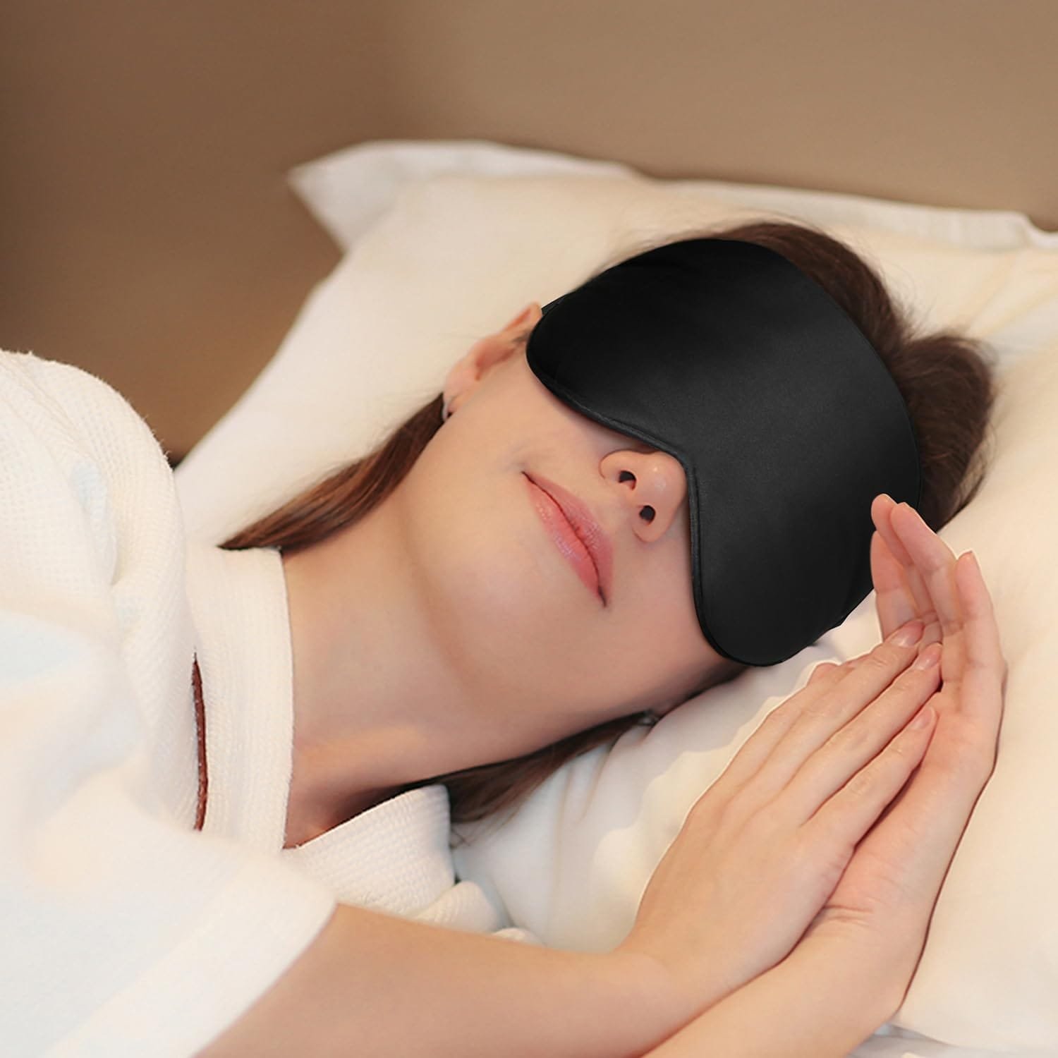Silk sleep mask in black with adjustable strap on a white background