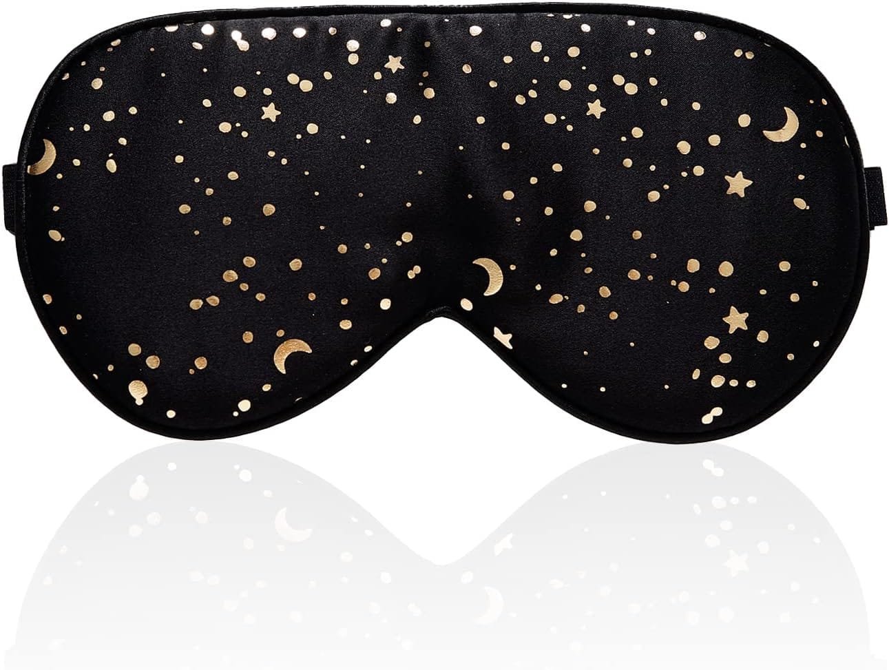 Silk sleep mask resting on soft bedding