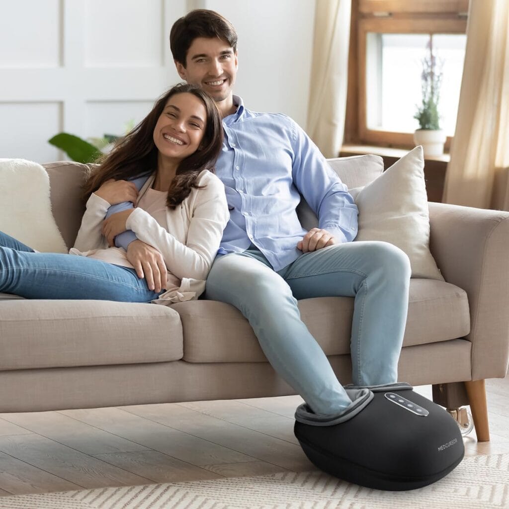 couple using an electric foot massager at home